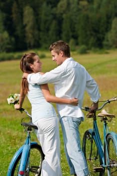Summer - romantic couple with old-fashioned bike in nature