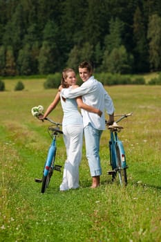 Summer - romantic couple with old-fashioned bike in nature