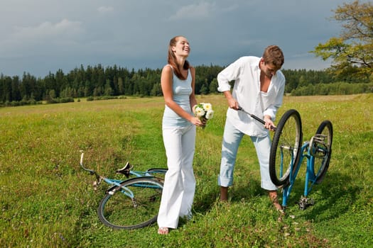 Summer - romantic couple with old-fashioned bike in nature