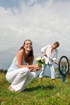 Summer - romantic couple with old-fashioned bike in nature