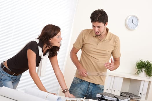 Young man and woman working at architect office