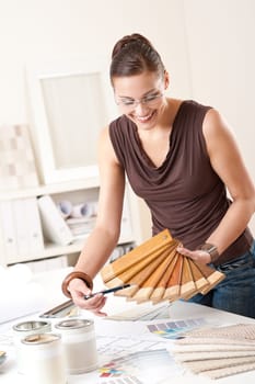 Young female designer with wooden color swatches