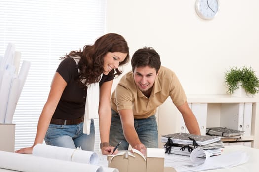 Young man and woman working at architect office