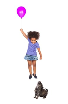 Puppy girl looking at a fly with ballon
