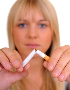 Young woman breaking a cigarette