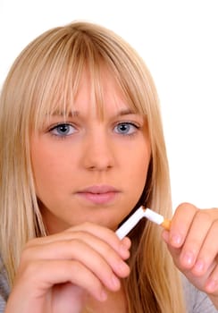 Young woman breaking a cigarette
