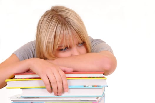 Exhausted young woman on pile of books