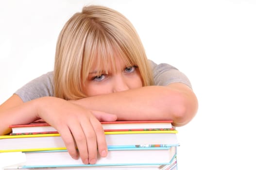 Exhausted young woman on pile of books