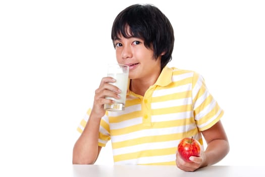 Boy with milk and apple