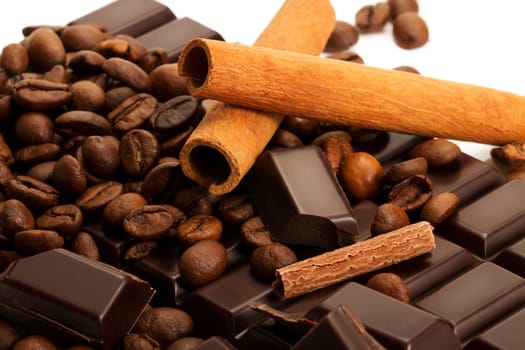 Coffee beans cinnamon on chocolate bar