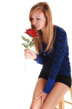 Girl smelling rose.
