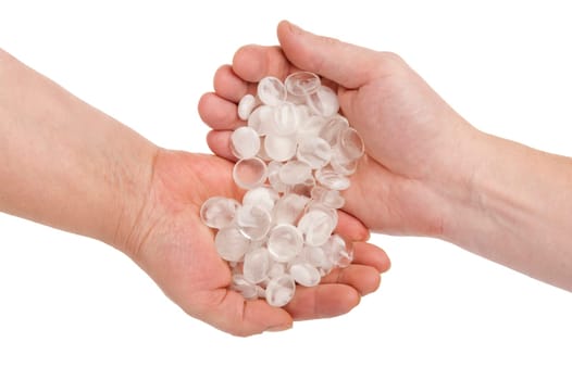 Pellucid stones in hands on white backgr