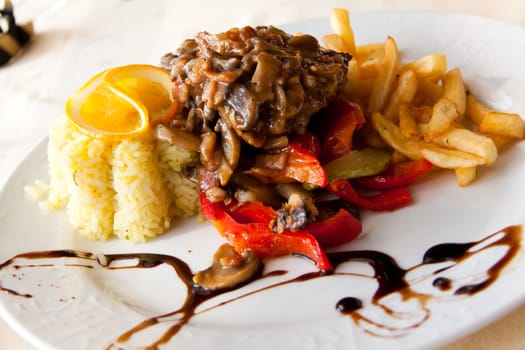 Veal schnitzel with rice and french fries
