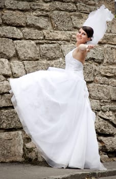 Bride  posing against old wall