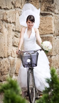 Bride  posing on bicycle
