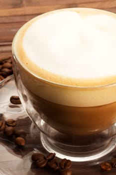 Cappuccino on plate with coffee beans
