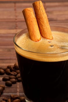 Cinnamon sticks in a glass with espresso