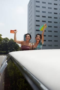 friends with shopping bags and limousine