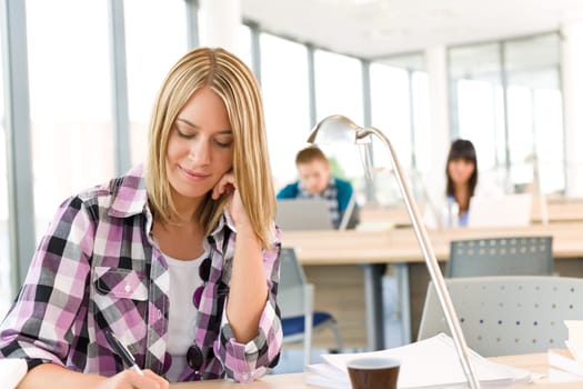 Back to school - female student writing notes