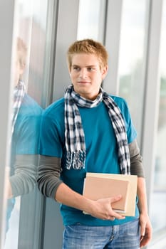 Male teenage student with books