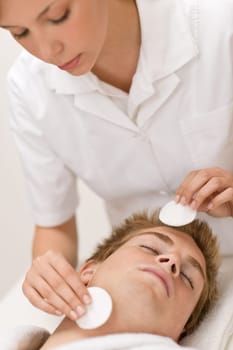 Male cosmetics - cleaning face in salon
