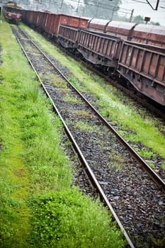 Cargo wagons in the train station during rain