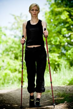 Nordic Walking - young woman is hiking