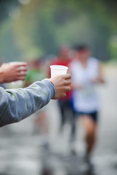 Runner take a water in a marathon race