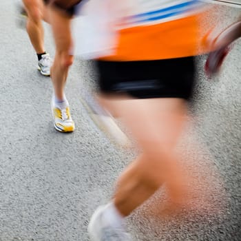 People running in city marathon