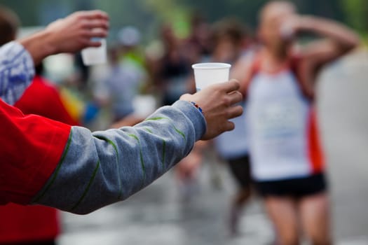 Runner take a water in a marathon race
