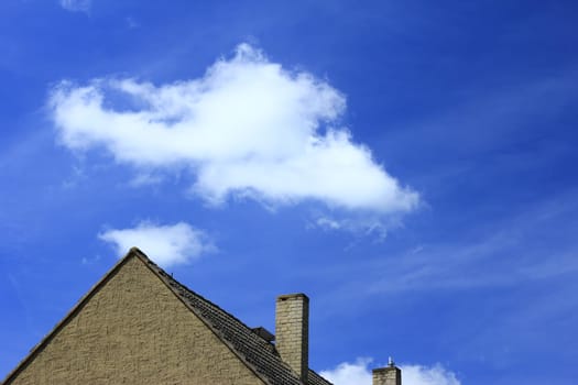 Gable and cloud in front of blue sky