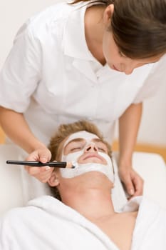Man cosmetics - facial mask in salon