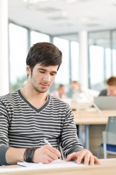 High school - Young male student write notes