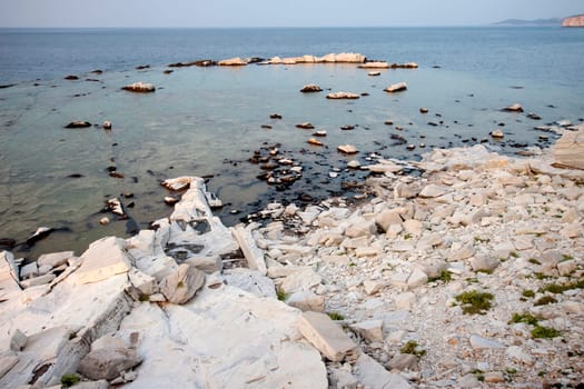 Blocks of marble in the sea on Aliki