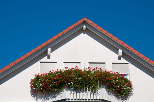 White house with red flowers