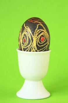 colorful easter egg in white egg cup