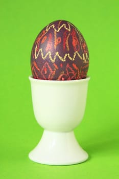 colorful easter egg in white egg cup