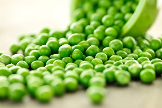 Spilled bowl of green peas