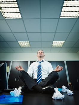 businessman doing yoga in office