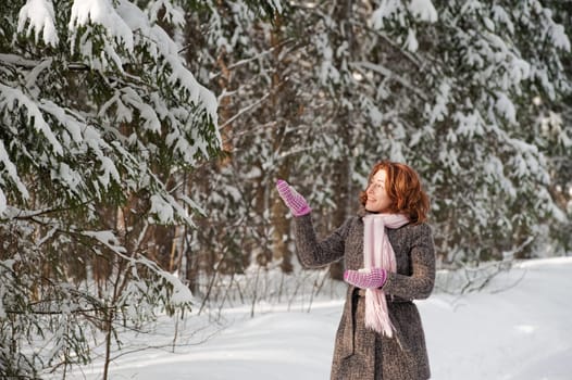 Happy red-haired woman having fun on win