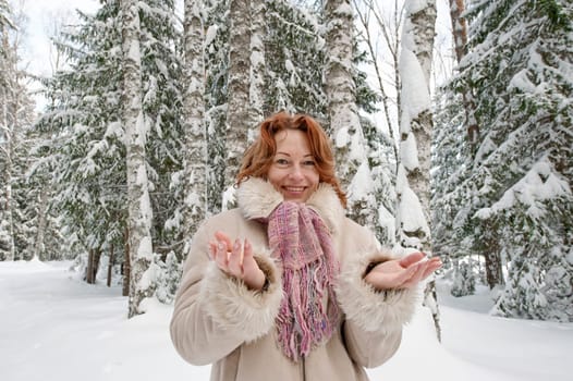 Smiling red-haired woman having fun on w