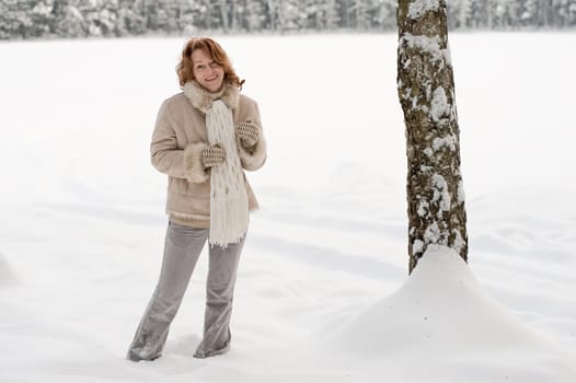 Happy red-haired woman having fun on win