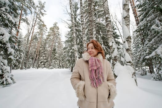 Red-haired woman having fun on winters d