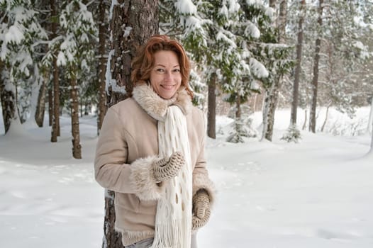 Smiling red-haired woman having fun on w