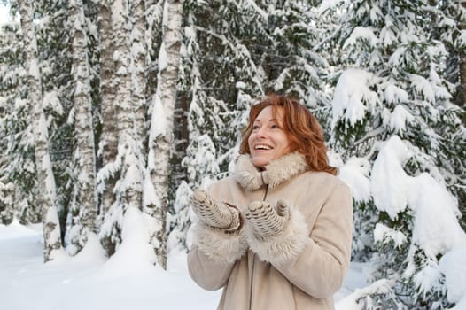 Happy red-haired woman having fun on win