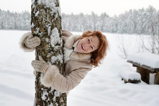 Portrait of happy red-haired woman in wi