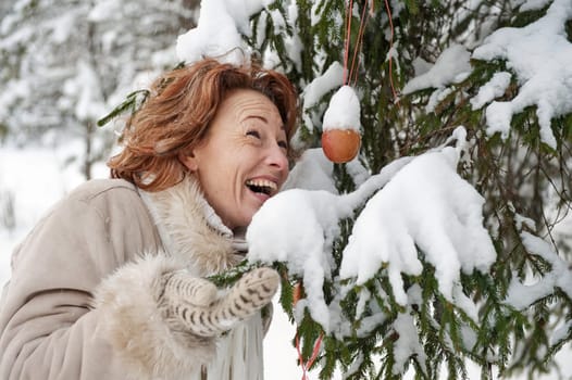 Portrait of happy red-haired woman in wi