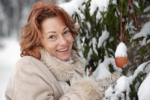 Portrait of happy red-haired woman in wi