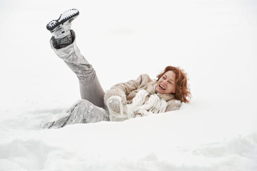 Attractive red-haired woman having fun i