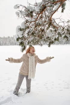 Happy red-haired woman having fun on win